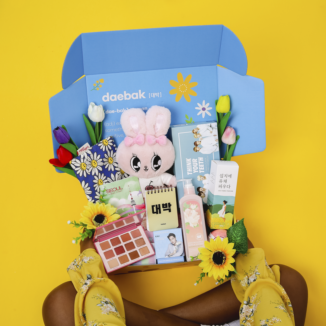 Open DaebakBox spring themed DaebakBox with assorted Korean snacks and goodies inside, ready to be enjoyed.