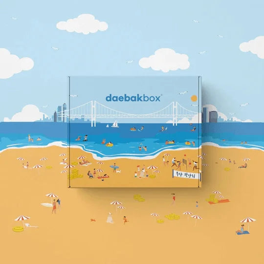 Daebak Summer Box filled with Korean skincare, makeup, snacks, and lifestyle items in vibrant, summer-themed packaging.