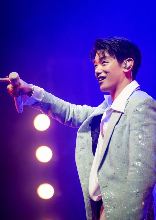 Eric Nam performs during his world tour concert at Yes24 Live Hall in Seoul wearing a white suit with blue stage lights