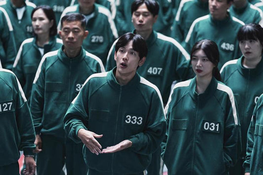 K-drama Halloween costume inspiration: Squid Game players in matching teal-green tracksuits with white piping and large player numbers