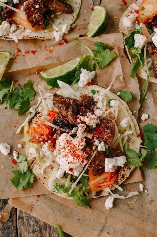 Korean Mexican fusion beef bulgogi taco with kimchi cabbage cilantro and lime