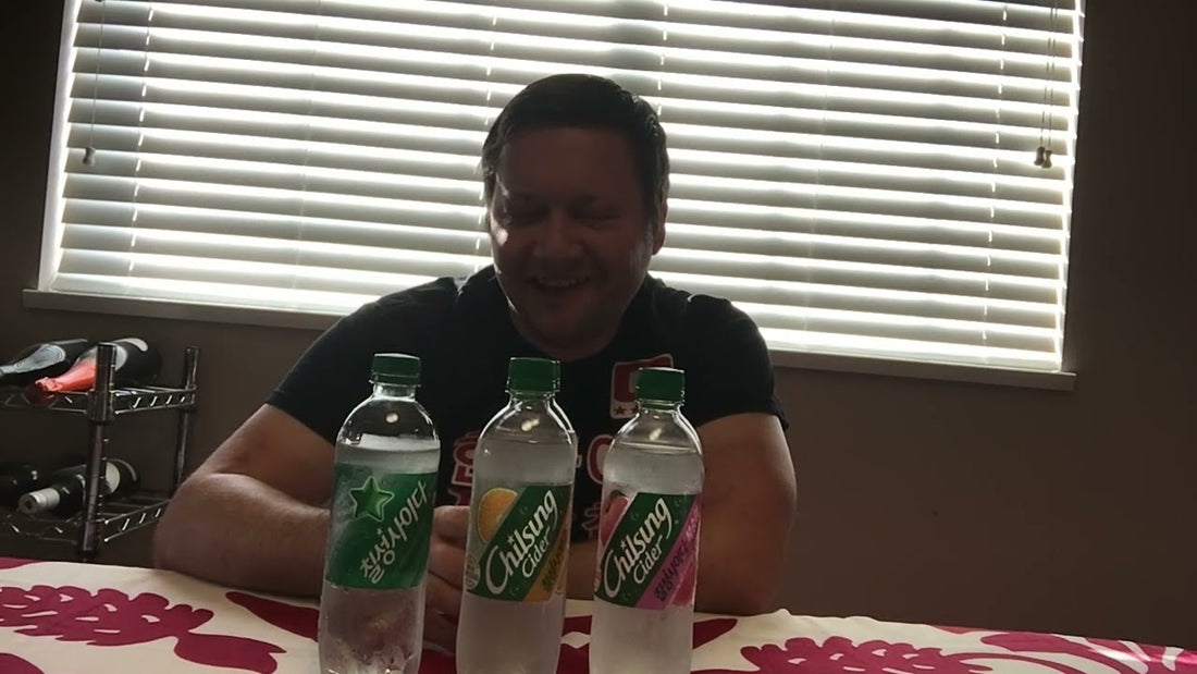 A clear glass bottle of Korean Lotte Chilsung Cider lemon-lime soda displayed with the iconic green and silver Korean label on a table