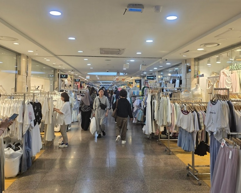 Shoppers walk through Goto Mall, the 880-meter underground shopping center beneath Seoul's Express Bus Terminal Station, lined with fashion and accessory vendors