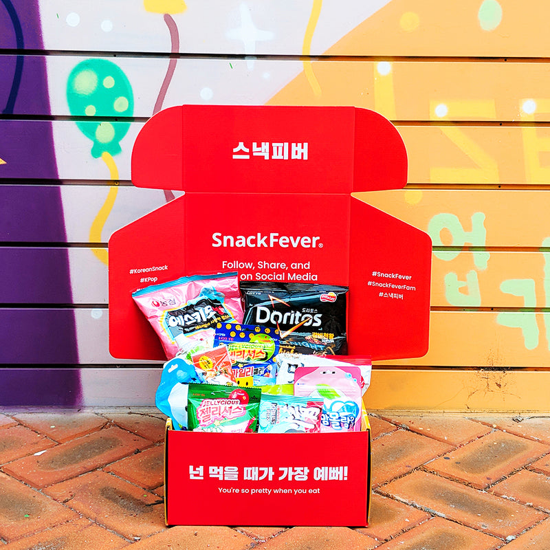 Open Snack Fever box in front of a painted wall