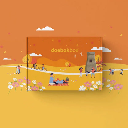 Daebak Fall Box featuring Korean skincare, cozy accessories, seasonal snacks, and lifestyle items in warm, autumn-inspired packaging.